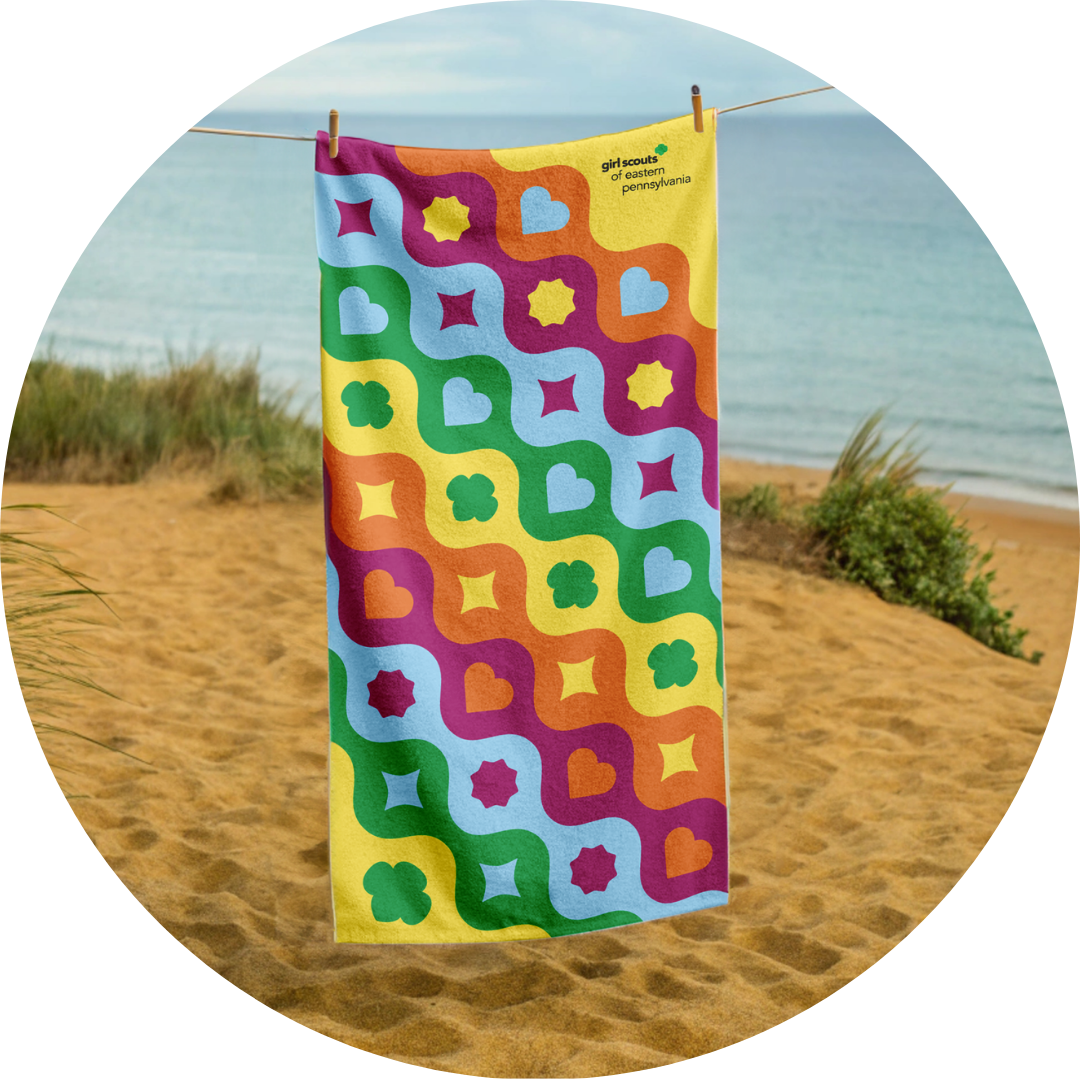 GSEP Branded Towel with yellow, orange, magenta, sky blue, and green waves with various shapes.